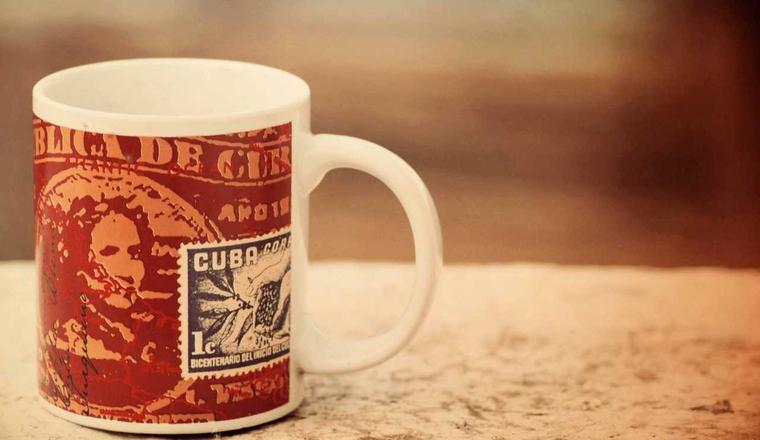 A printed ceramic mug on a wooden table