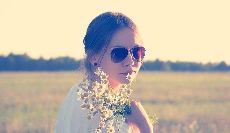 Portrait of a person holding wildflowers